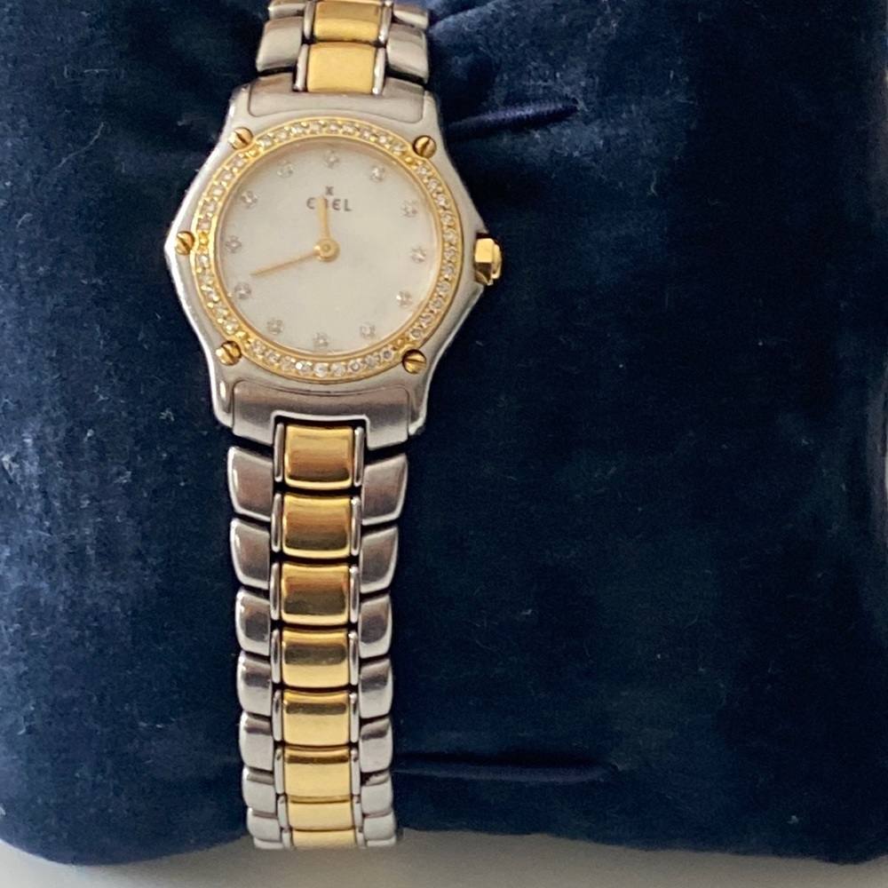 An EBEL women stainless steel and gold band watch with gold and diamond bezel